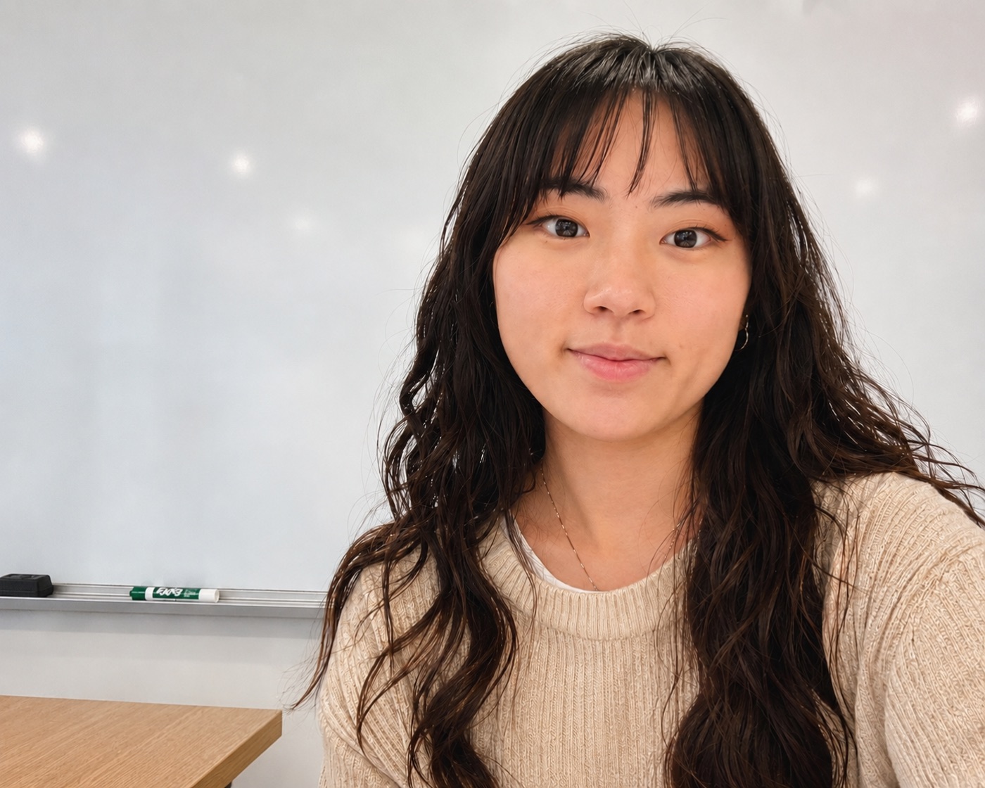 Ms. Ji, smiling warmly in her classroom